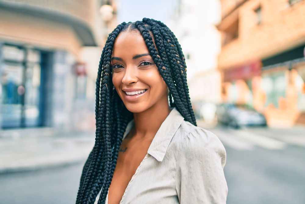 Young African American woman smiling happy walking at the city.
