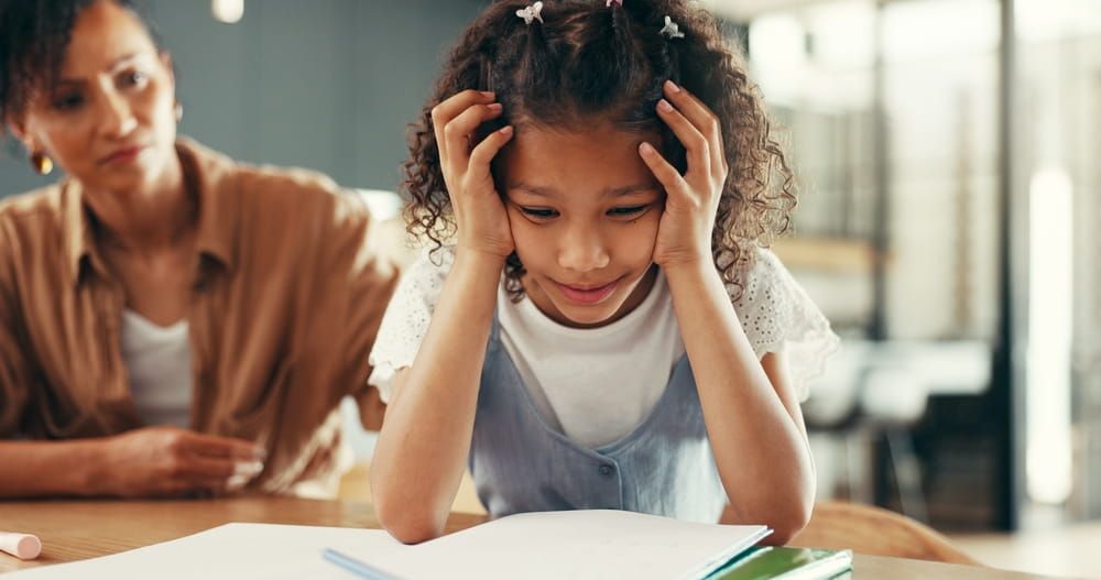 Mom, girl and stress with education, homework and guide for learning disability with books at apartment