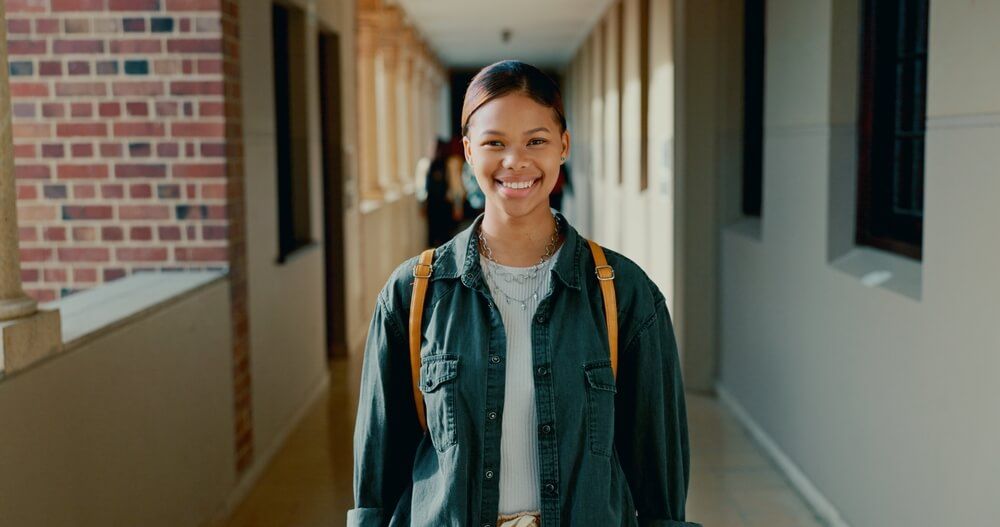 teenage girl is smiling in the school hallway