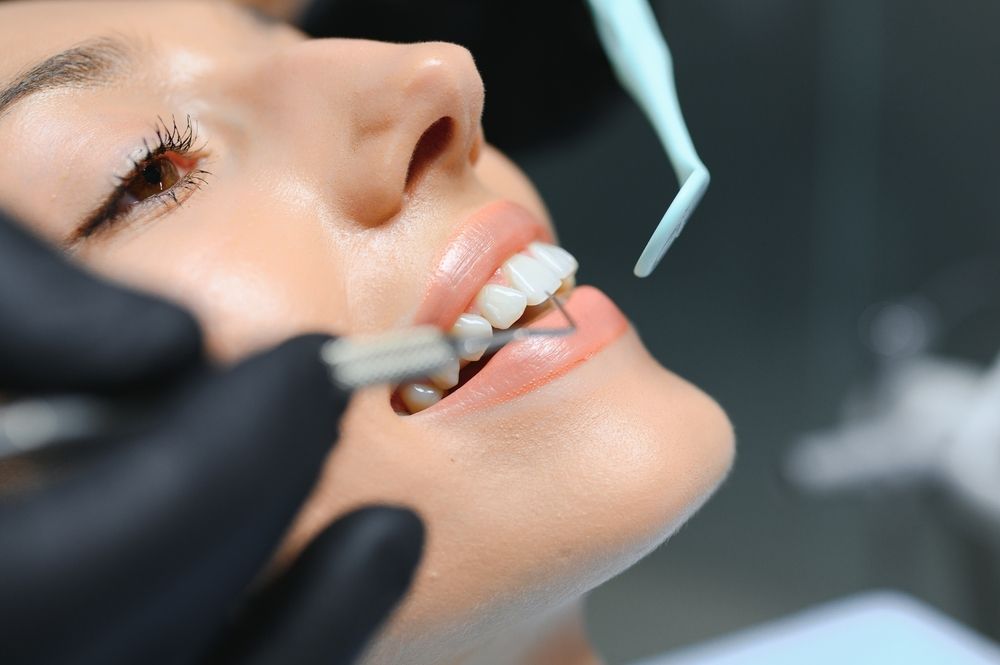 Doctor examining patient's teeth, closeup. Cosmetic dentistry.