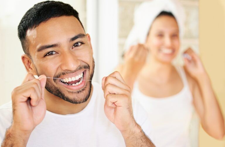 Flossing is just as important as brushing your teeth. Shot of a happy young couple