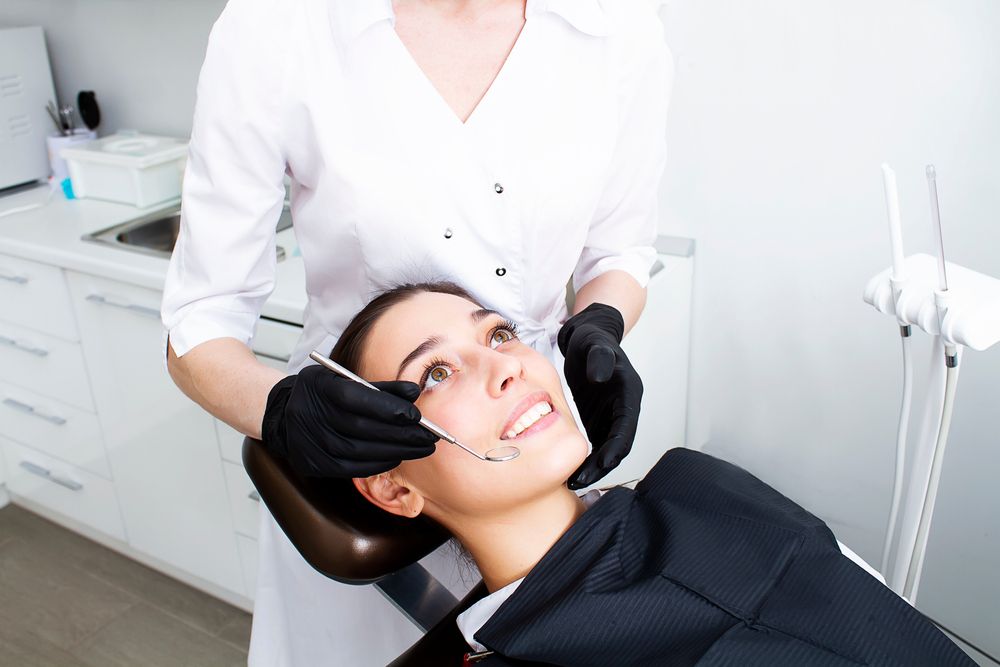 Gum treatment. Periodontist and patient at dentistry clinic. Periodontology