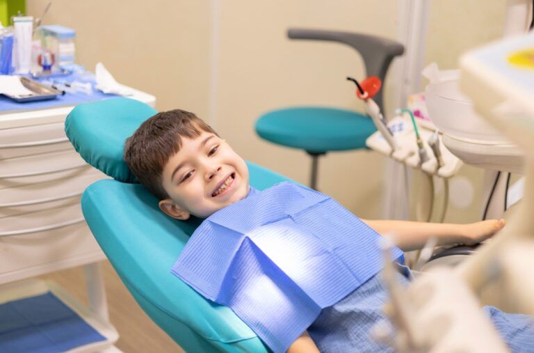 kid in dental office. dentist checking child teeth