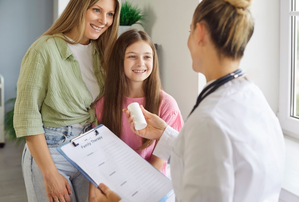 Mother and child meet pediatrician for clinic consultation