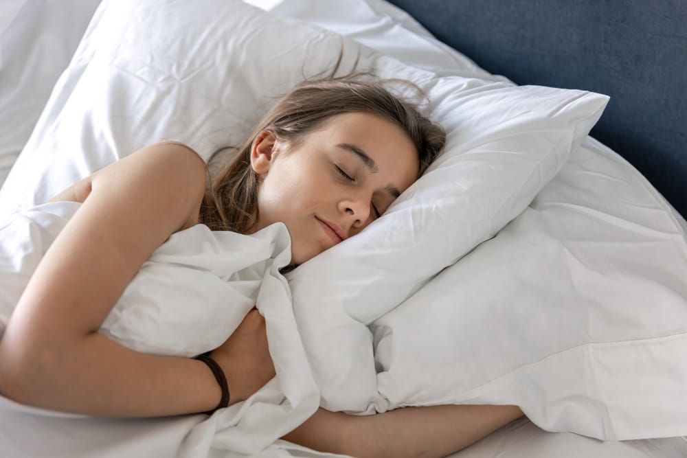 Peaceful girl sleeping. Cozy bedroom. Healthy rest