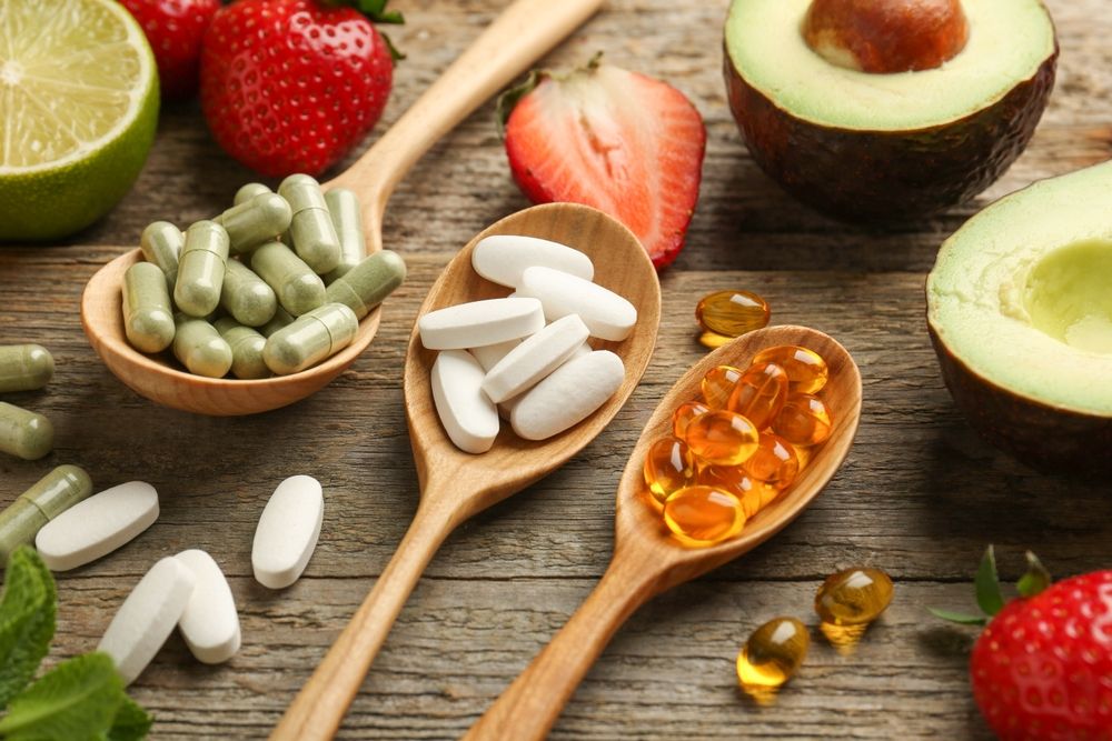 Different,Vitamin,Pills,And,Fresh,Fruits,On,Old,Wooden,Table