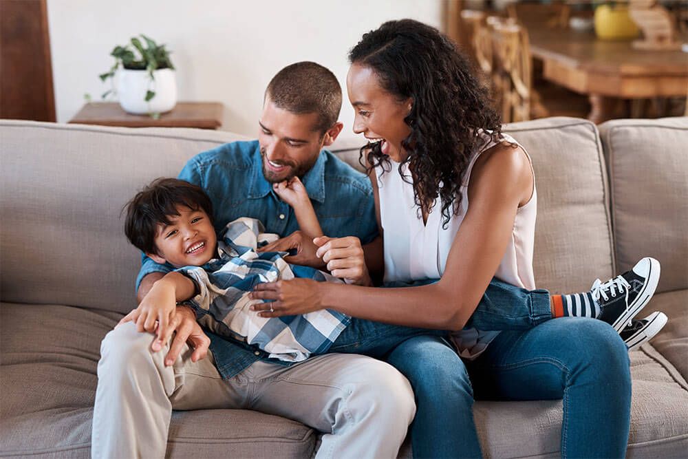 Family, laughing and tickle in home portrait, funny games and goofy bonding for love connection