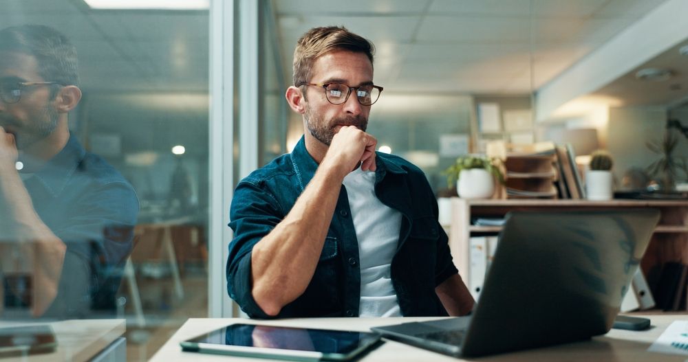 Businessman, reading and office with laptop, report and confidence for bookkeeping as accountant