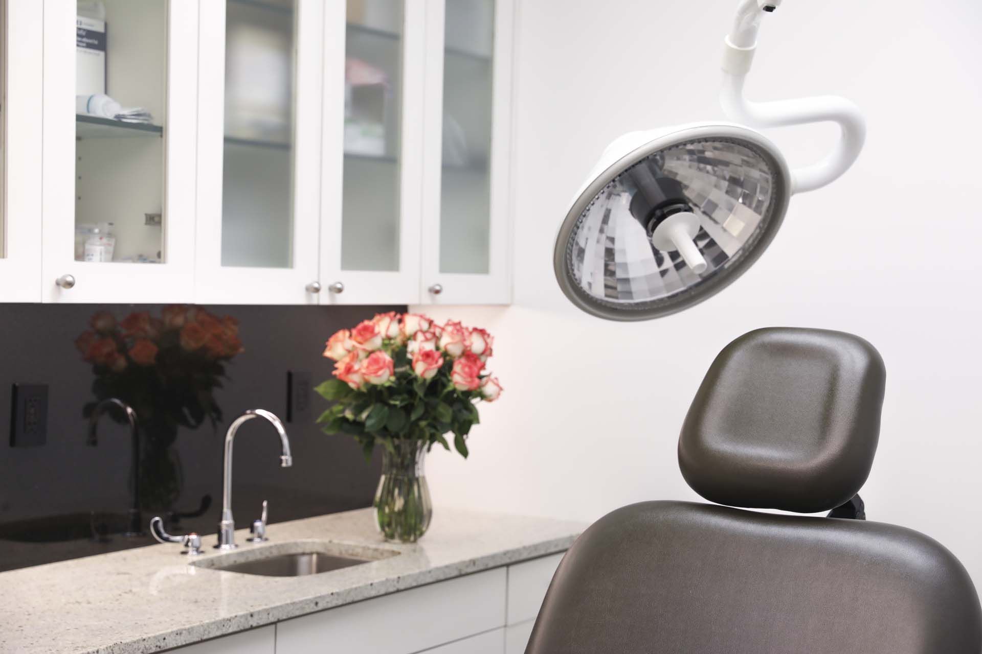 A high-intensity lamp mounted above the chair to provide clear visibility