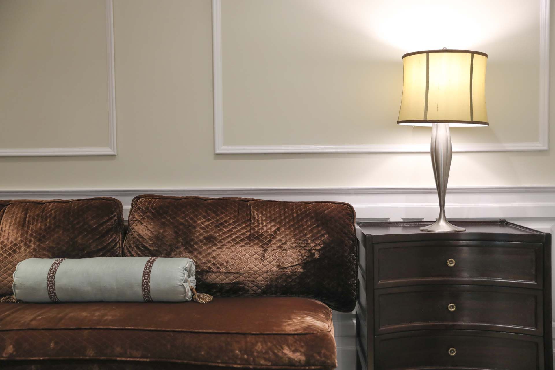 a luxurious interior scene with classic Italian décor including rich textiles and refined lamps.