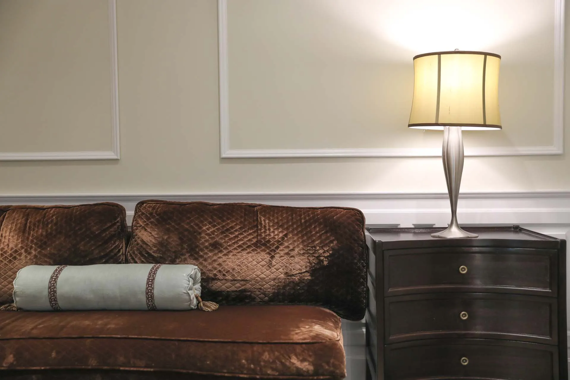 a luxurious interior scene with classic Italian décor including rich textiles and refined lamps.