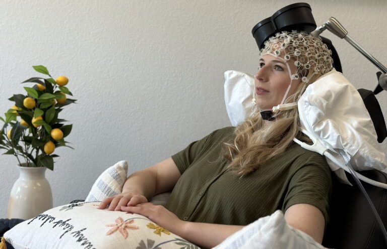 a woman undergoing a non-invasive brain therapy known as Transcranial Magnetic Stimulation (TMS)