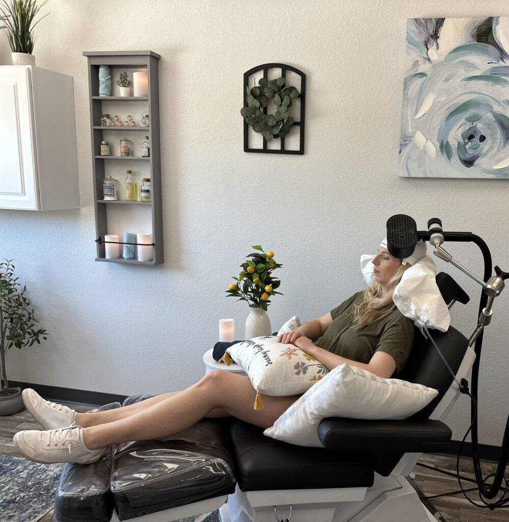 a woman undergoing a non-invasive brain therapy known as Transcranial Magnetic Stimulation (TMS)