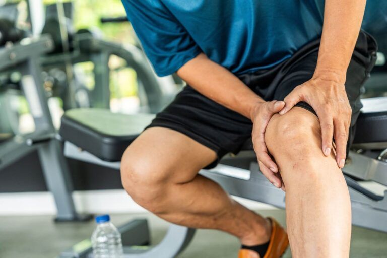 Mature man tired and leg pain during jogging at gym