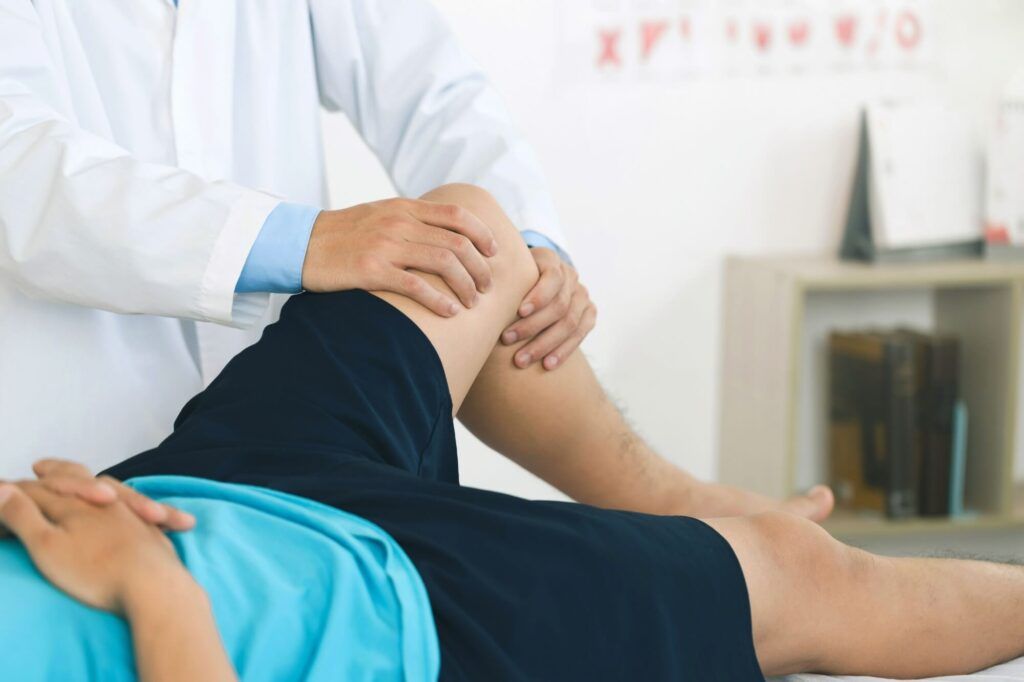 physiotherapist massaging the knee of a patient. rehabilitation and recovery after physical knee injuries