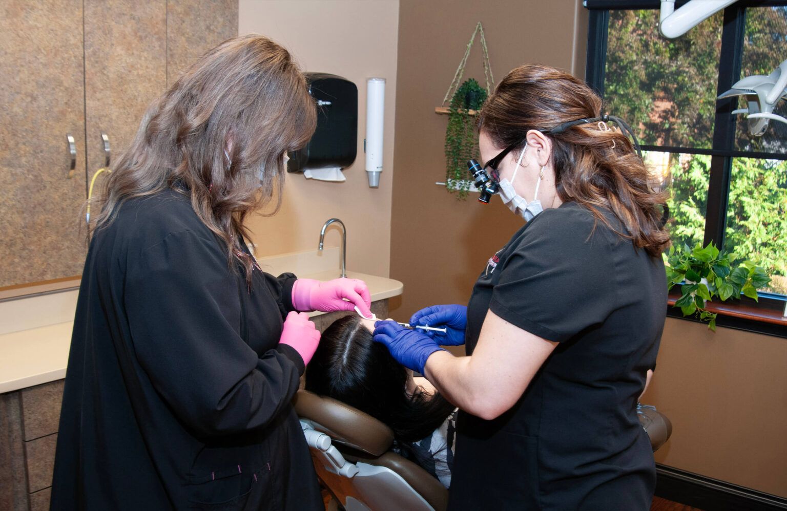 Dr. Yailin Diaz Pichardo doing dental procedure being performed in a dental office setting