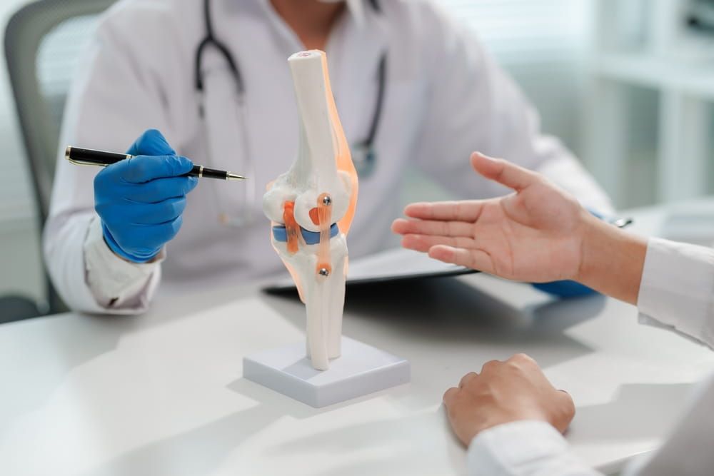 Discussion between doctor and patient on knee pain treatment.