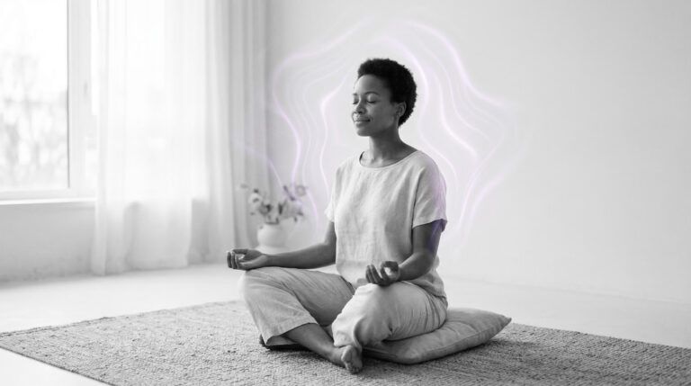 grayscale image of a person practicing calm breathing with eyes closed, soft daylight,